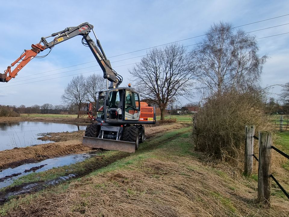 Mobilbagger Atlas 140W mit Tieflöffel am Ufer eines Klärteichs